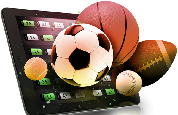 Мячи для футбола, тенниса, баскетбола и американского футбола рядом с планшетом, на котром открыт сайт букмекерской конторы