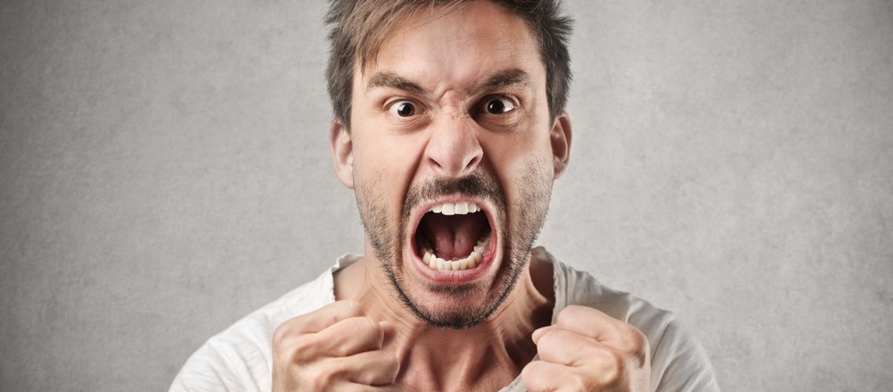 Симпатичный молождой мужчина кричит со всей силы