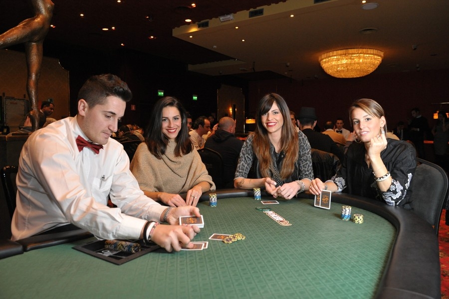 Три красивые женщины играют в покер с крупье