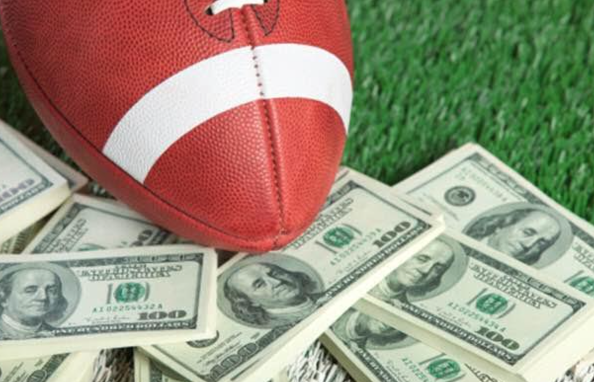 Мяч для регби лежит на куче денег